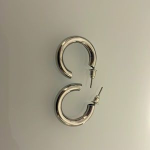 Silver, thick small hoop earrings.